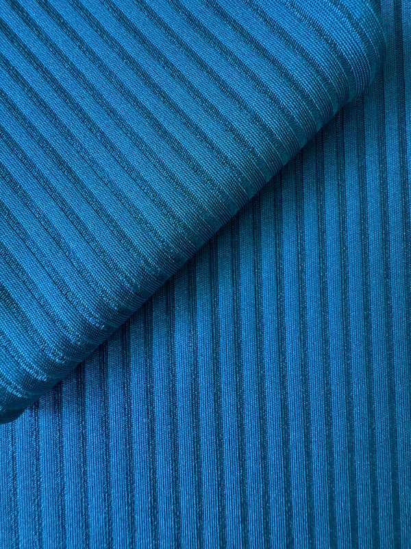 close up on lemlem Beri Teal Fabric featuring rich mid-blue green color and a soft, silky ribbed texture