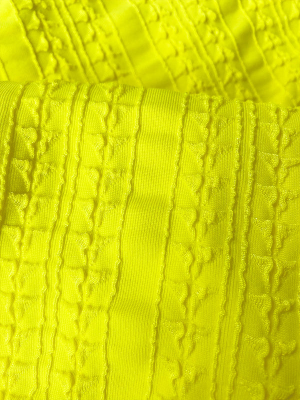 Close up on Jordanos Citron Fabric featuring a textured down sampled Jordanos pattern in a bright flattering citron color