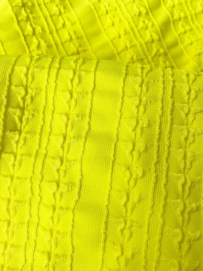 Close up on Jordanos Citron Fabric featuring a textured down sampled Jordanos pattern in a bright flattering citron color
