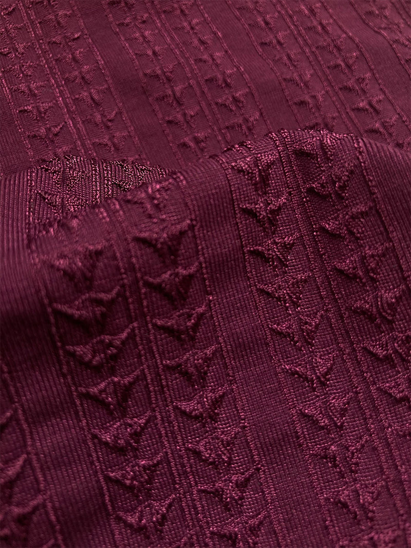 Close up on the fabric of the Jordanos Sara Tie Front Top featuring a downsampled Jordanos Pattern in a luxurious burgundy hue