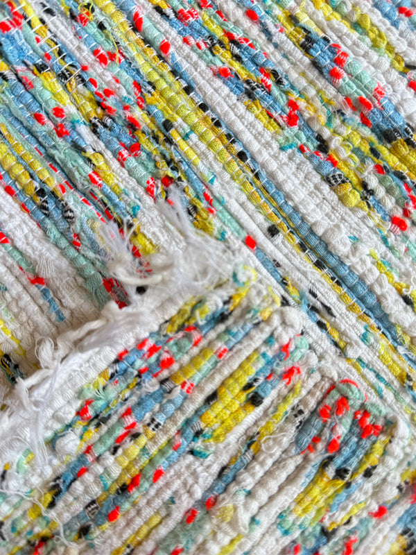 Product shot of lemlem upcycled handwoven MESFIN Rug with multicolored patterns