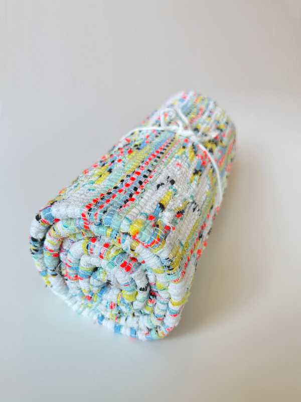 Product shot of lemlem upcycled handwoven MESFIN Rug with multicolored patterns