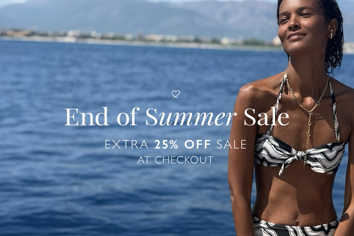 Liya Kebede wearing a black and white patterned halter bikini stands by the ocean with promotional text reading 'End of Summer Sale' and 'EXTRA 25% OFF SALE AT CHECKOUT'.