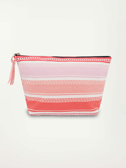 Product picture of a pink travel pouch featuring horizontal solid and doted pink and lilac stripes and a black zip closure at the top.