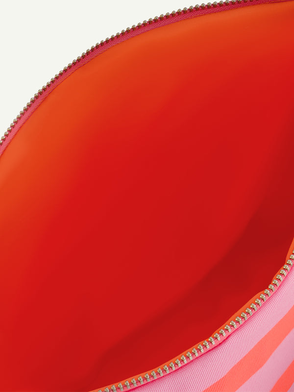 Product Close up Shot of lemlem pouch featuring bold and vibrant neon orange red, accented by soft rose stripes, offering a fresh twist on the classic cabana stripe