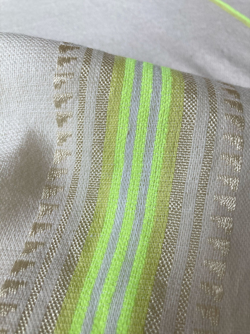 Сlose up on Lomi Keylime Fabric featuring combination of matte and shine natural tibebs and stripes in Vanilla Cream and Lime sorbet colors.