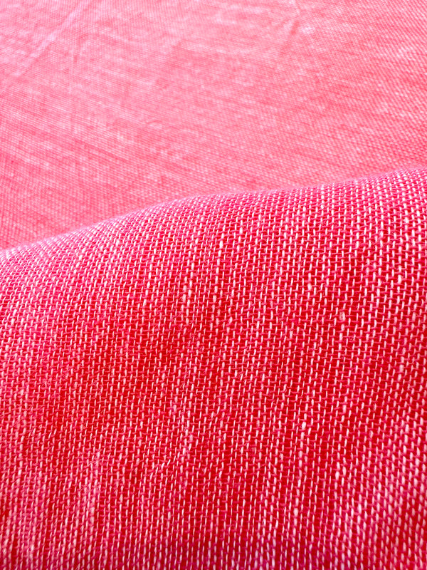 close up on lemlem sheer fabric in pink watermelon color