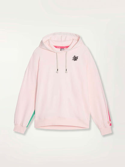 Product Shot of a Puma x lemlem oversized hoodie in Frosty Pink  Color featuring hand sketched cat logo and color block stripes in bright pink and yellow colors. 