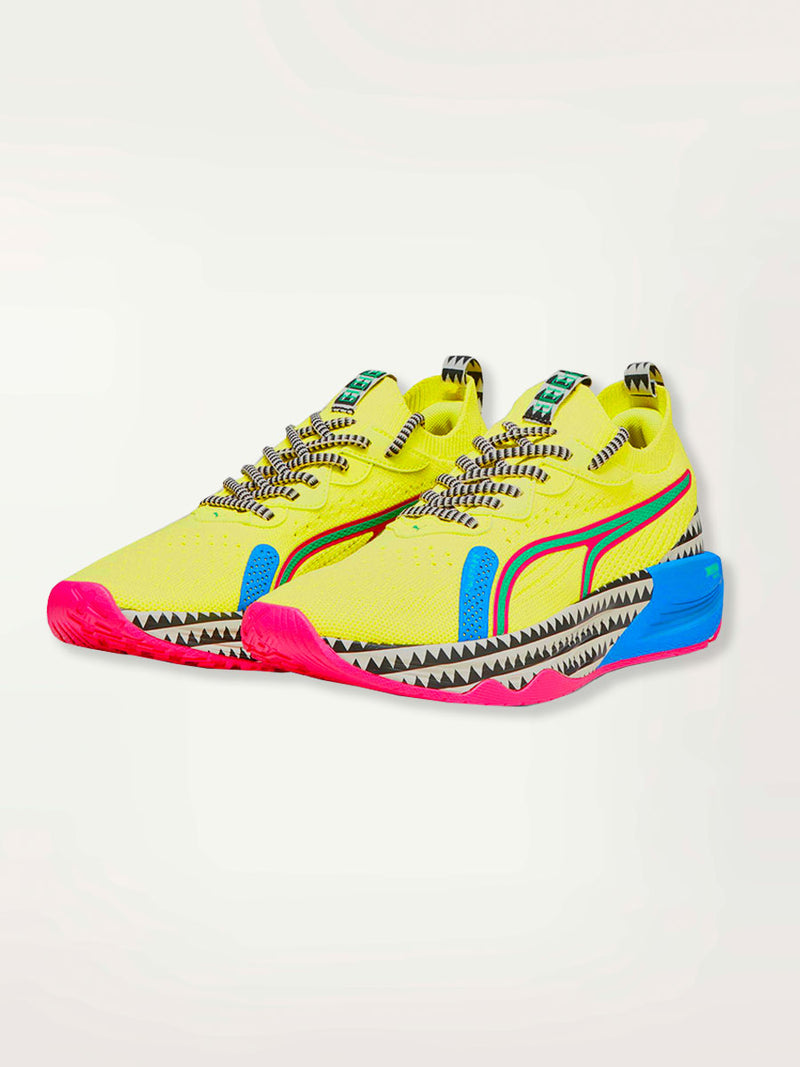 Product Side Shot of a Puma PWR XX NITRO™ Women's Training Shoes featuring a premium knitted upper highlighted with bright color details and lemlem’s traditional triangle print.