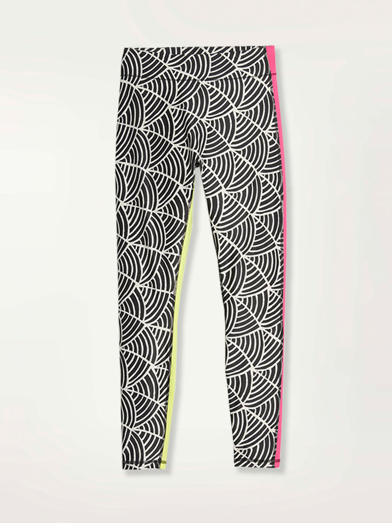 Product Shot of a Puma x lemlem leggings featuring hand sketched scallop print in Ghost Pepper and Black colors and color block side stripes in bright pink and green colors
