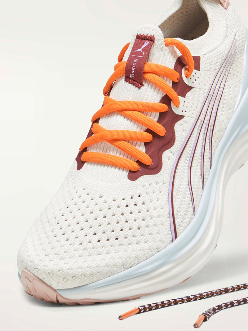 Product Upper Shot of a Puma x lemlem ForeverRUN Nitro Shoes featuring Icy Blue, Warm White, colors and color details in Cayenne Pepper and Team Regal Red  and laces with lemlen triangle pattern