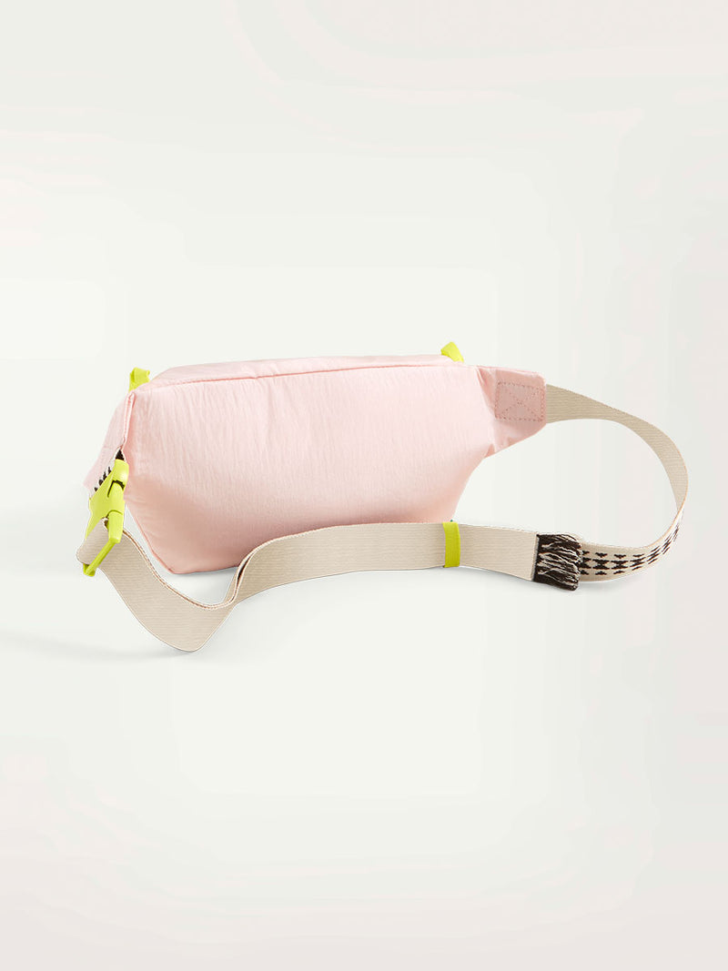 Product Back Shot of a lemlem waist bag in frosty pink color featuring color block zipper and lemlem triangle pattern strap