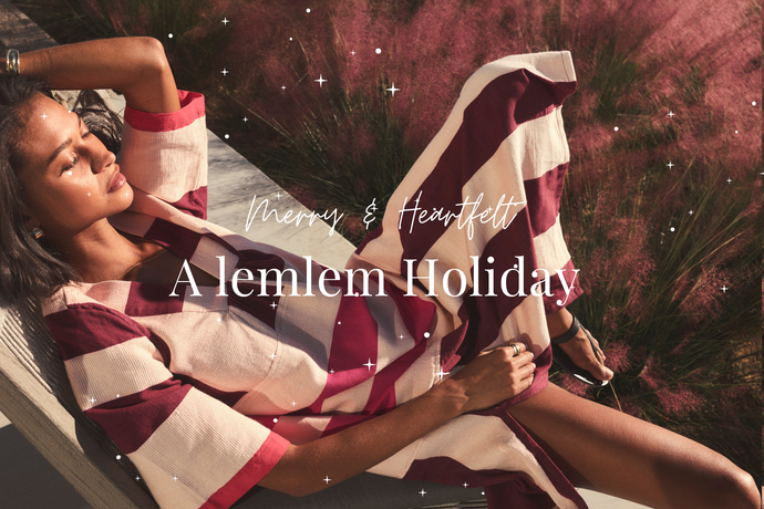 Woman wearing red and white dress with 'Merry & Heartfelt A lemlem Holiday' text.