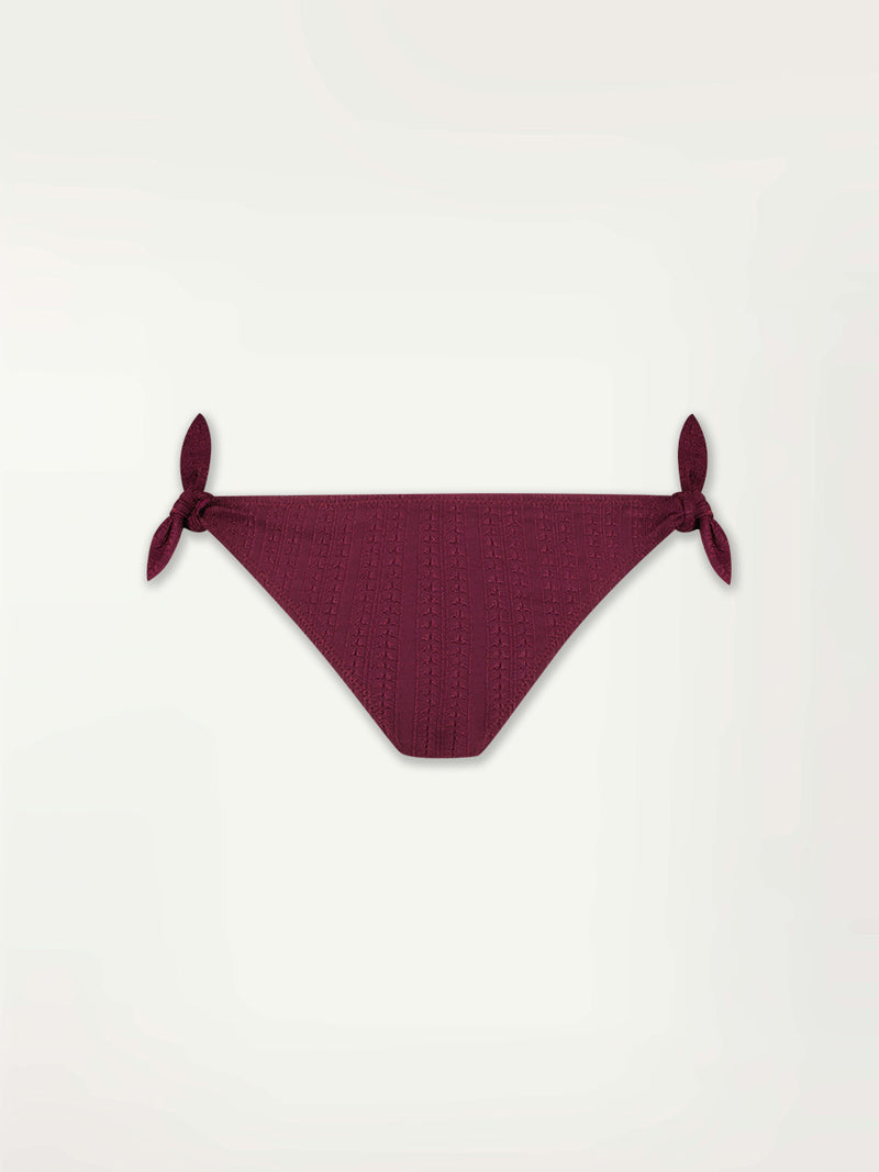 Product Front shot of a Lucy Side Tie Bottom Featuring featuring a downsampled Jordanos Pattern in a luxurious burgundy hue
