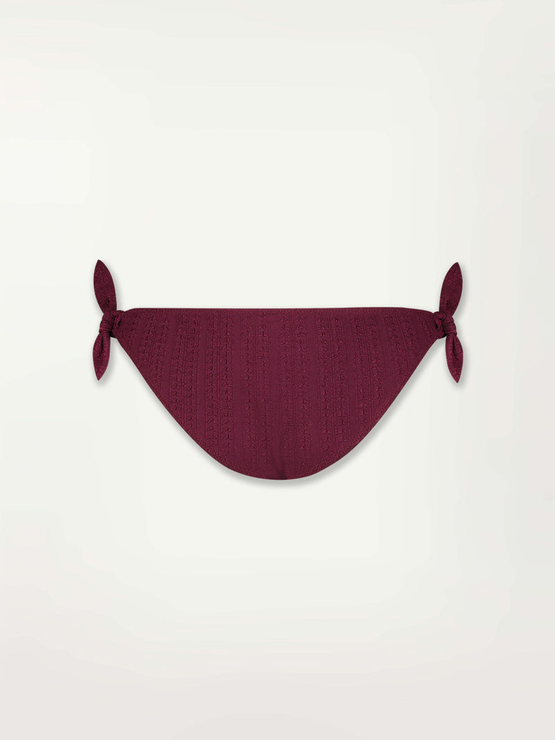Produc back shot of a Lucy Side Tie Bottom Featuring featuring a downsampled Jordanos Pattern in a luxurious burgundy hue