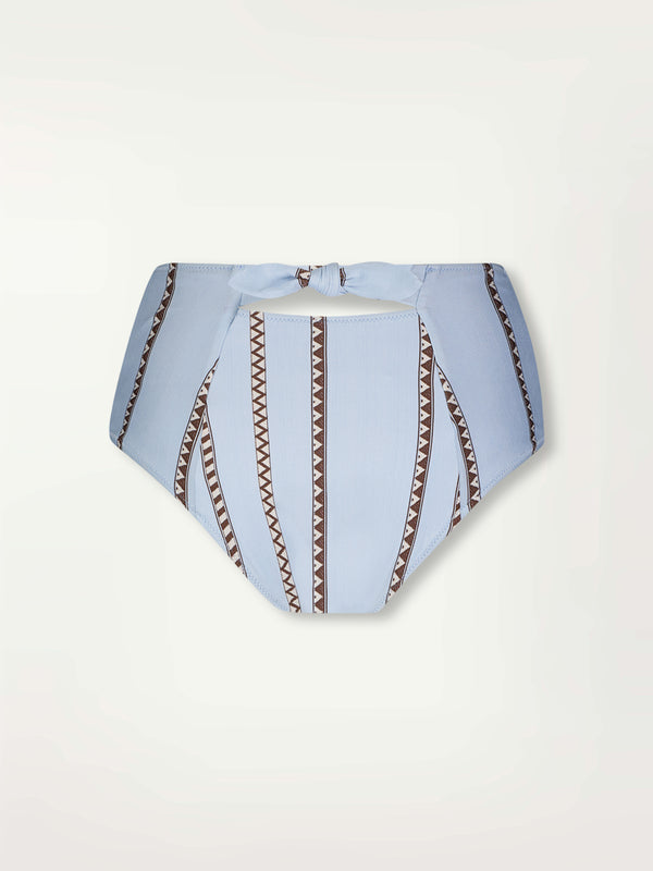 Product Back Shot of Elsi High Waist Bikini Bottom featuring intricate bands of dark earth and ivory Tibeb patterning on a pale sky blue background.