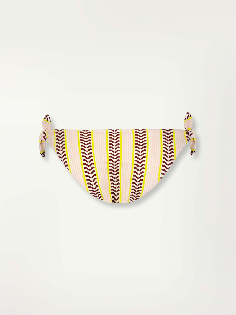 Product Back Shot of a Lucy Side Tie Bottom featuring delicate pink stripes with a bold chevron patterned ribbon, along with muted hues of pink, burgundy, and a bright citrus hue.
