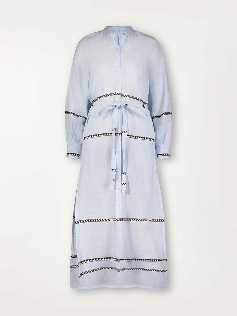 Product Front Shot of the Makeda Button UP dress featuring  intricate bands of dark earth and ivory Tibeb patterning on a pale sky blue background.