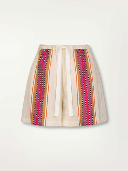 Product Front Shot of Safia Shorts featuring stripe pattern in magenta, ochre, and berry tones, delineated by black and white dots and accented with a splash of neon orange on natural cotton background
