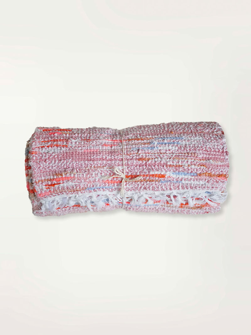 Rolled Up Coral Rug Featuring Coral Color Stripes and Blue Stripes
