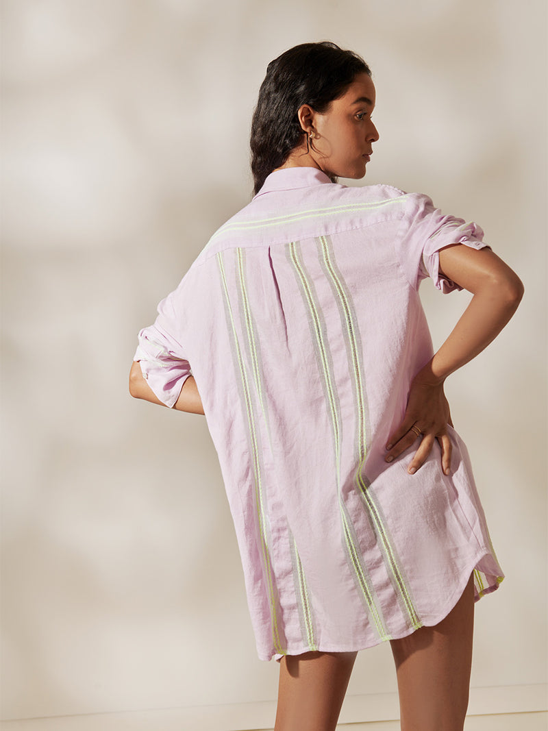 Back view of a Woman Standing Wearing Mariam Shirt Featuring lilac orchid color complemented by hints of citron neon