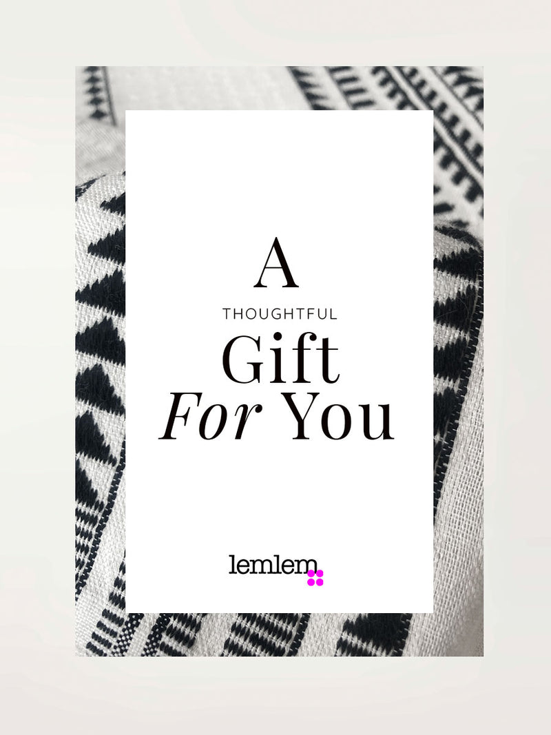 Gift card with "a happy gift for you" text, lemlem logo and close up of yani black fabric on the background