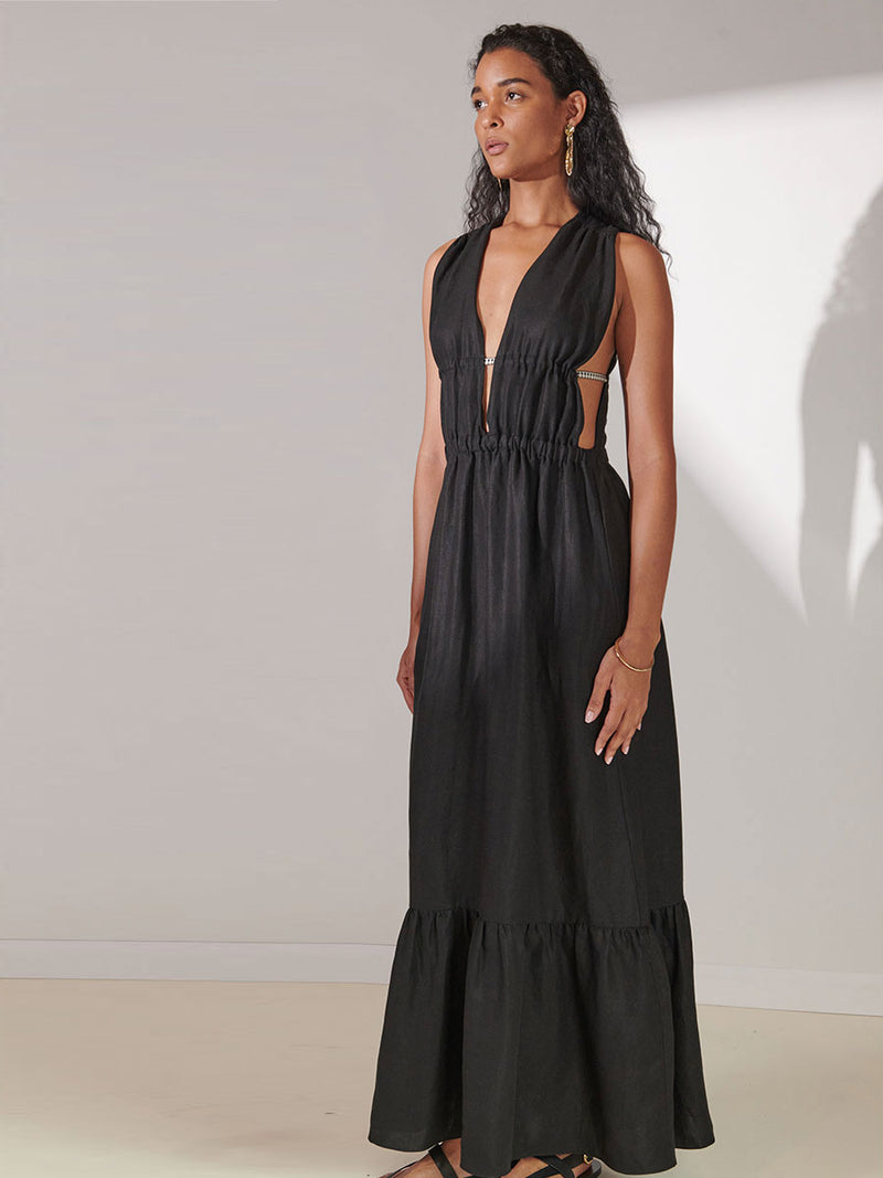 Side View of a Woman Standing Wearing lemlem Lelisa V Neck Dress in Black Color