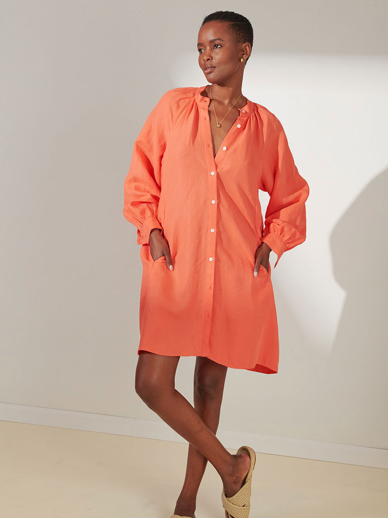 Woman Standing Wearing lemlem Meaza Button Up Dress in Coral Color
