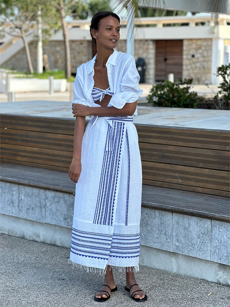"Liya Kebede stands on the street wearing a Yani Wrap Skirt, Yani Bandeau Top, and a white shirt