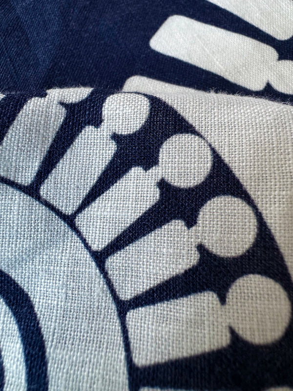 close up on lemlem zeina navy linin fabric Featuring a bold geometric medallion pattern on navy background, inspired by traditional Tibeb motifs.