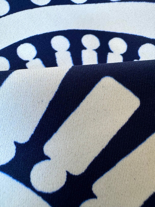 close up on lemlem zeina navy swim fabric Featuring a bold geometric medallion pattern on navy background, inspired by traditional Tibeb motifs.