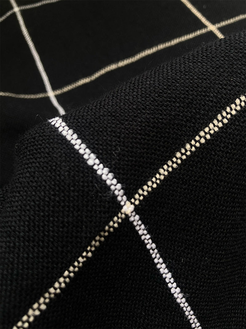 Close Up on Zeki Black Fabric featuring big white plaid pattern on black cotton background