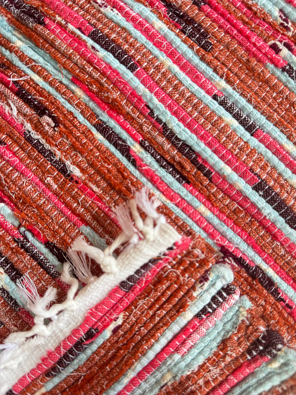 Product shot of lemlem upcycled handwoven MESFIN Rug with multicolored patterns