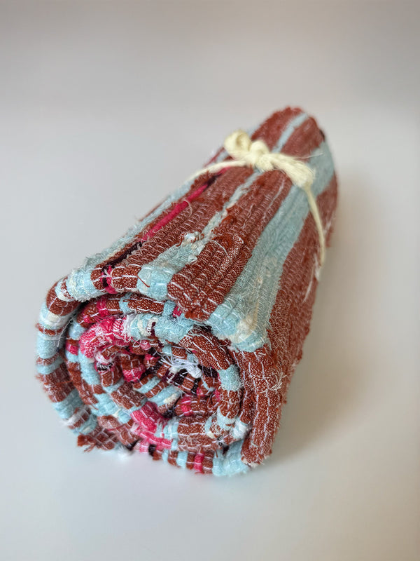Product shot of lemlem upcycled handwoven MESFIN Rug with multicolored patterns