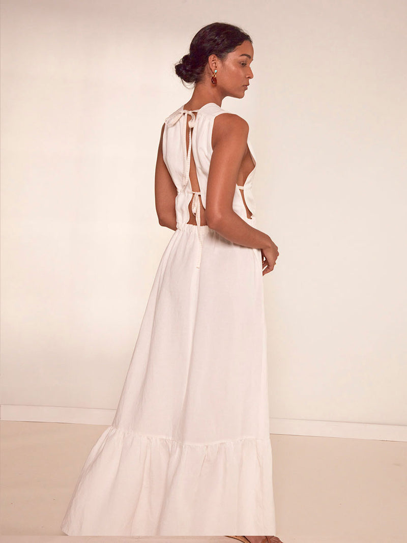 Back View of a Woman Standing wearing Woman Standing Wearing lemlem Lelisa V Neck Dress in white color