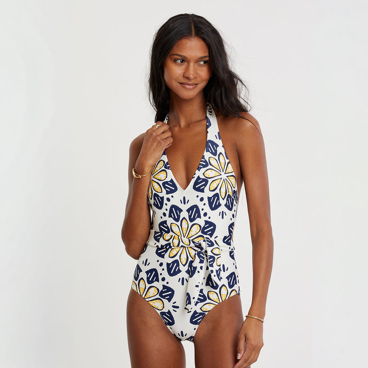 Woman wearing a floral-patterned swimsuit on a white background