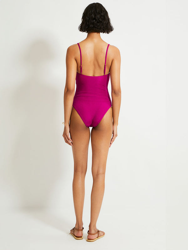 Back of a Woman Standing Wearing lemlem ELENE One Piece featuring rich, opulent berry color