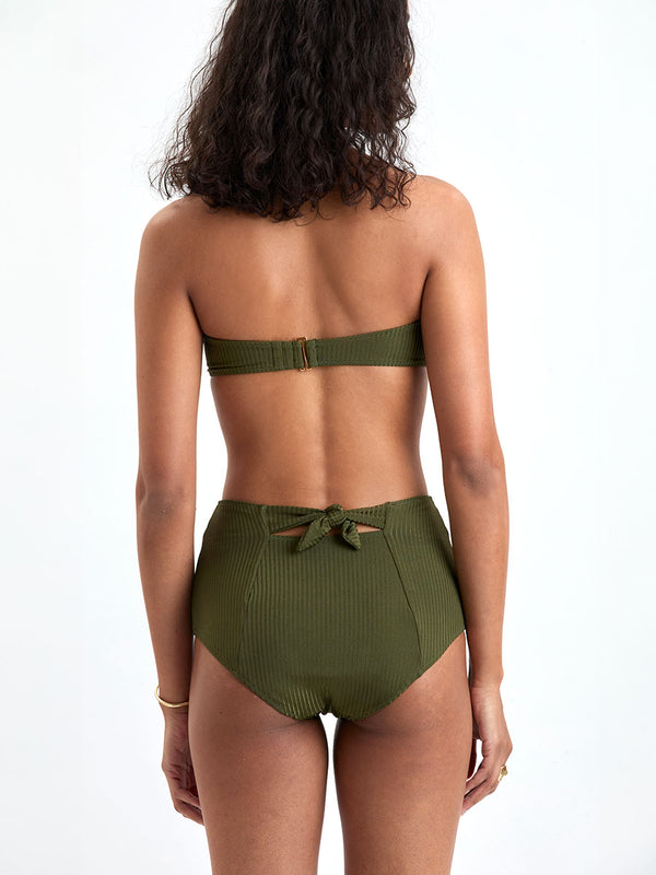 Back of a Woman wearing lemlem ELSI High Waist Bottom and AVA Bandeau Bikini Top featuring a rich olive green color and a soft, silky ribbed texture fabric