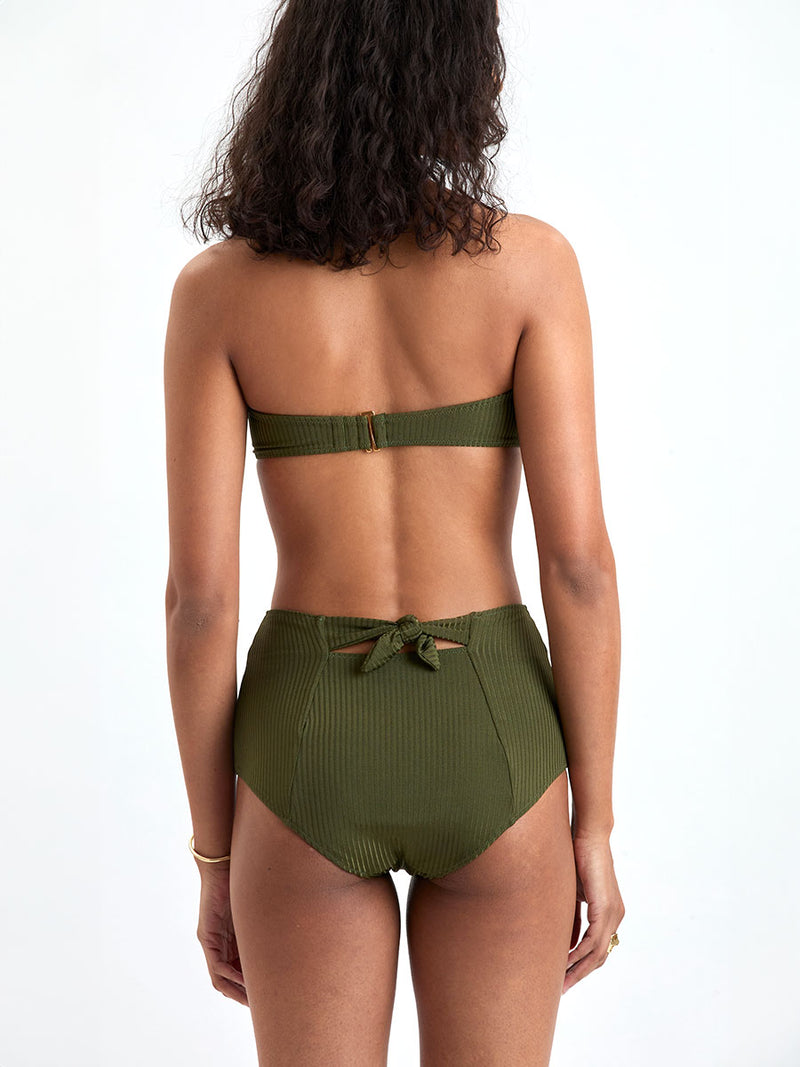 Back of a Woman wearing lemlem ELSI High Waist Bottom and AVA Bandeau Bikini Top featuring a rich olive green color and a soft, silky ribbed texture fabric