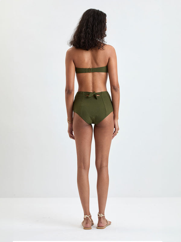 Back of a Woman wearing lemlem ELSI High Waist Bottom and AVA Bandeau Bikini Top featuring a rich olive green color and a soft, silky ribbed texture fabric