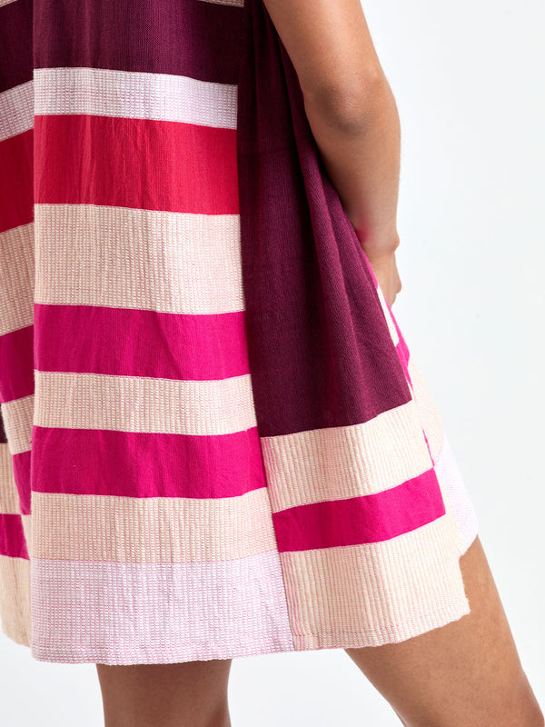 Close up shot on lemlem ELINA Caftan featuring a striking color-block combination of vivid magenta, scarlet, and burgundy colors.