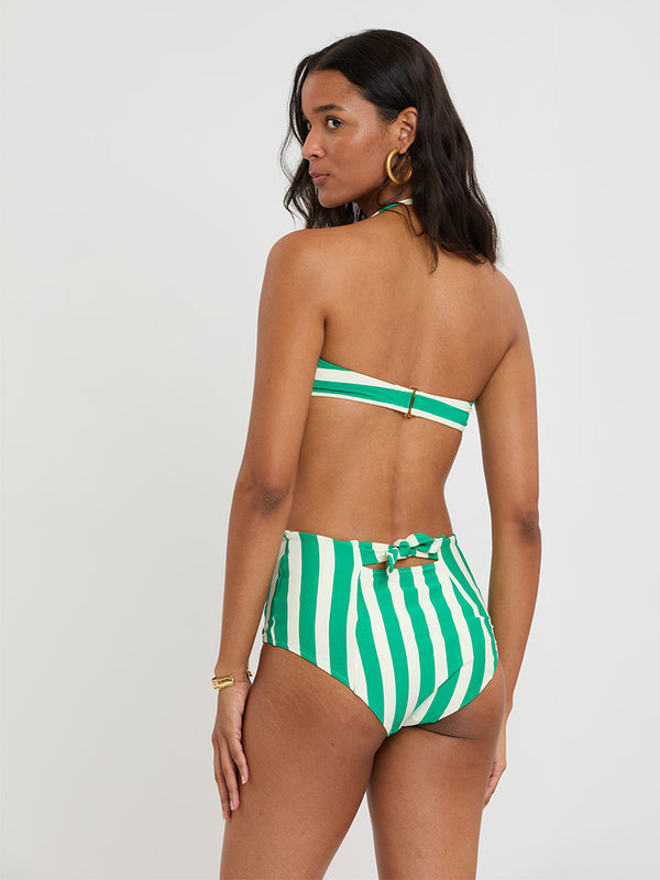 Woman Standing Wearing lemelm AVA Bandeau Top and ELSI High Waist Bottom featuring classic cabana stripe in classic green, accented by soft ivory.