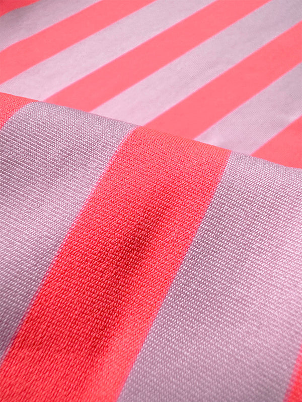 Close up on lemlem Chireti Pink Fabric featuring bold and vibrant neon orange red, accented by soft rose stripe