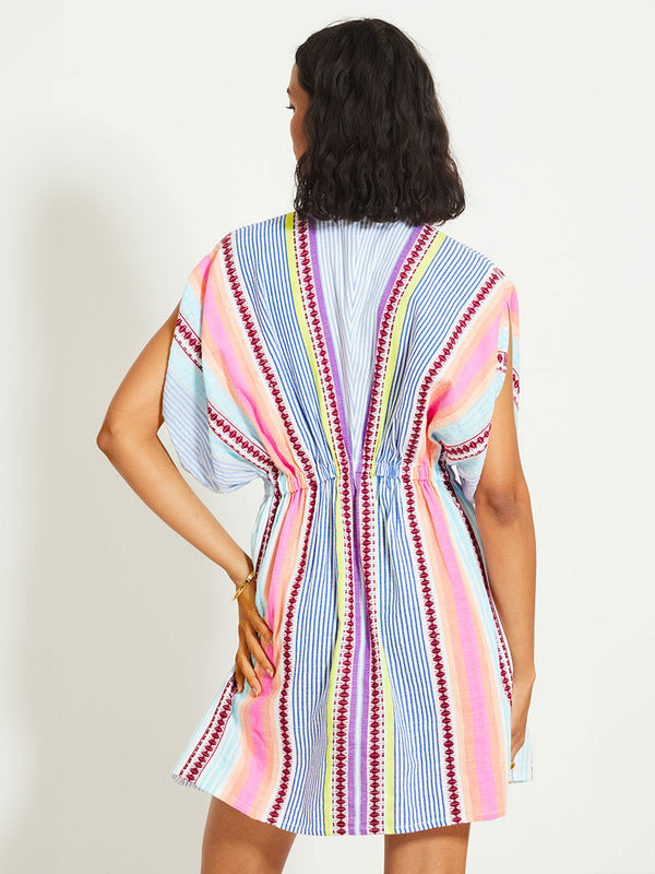 Back of a Woman Standing Wearing lemlem ALEM | Plunge Dress featuring  intricate stripes in sun-washed hues and a Tibeb-inspired pattern in rich dark plum