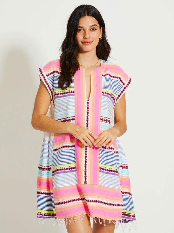 Woman Standing Wearing lemlem ELINA | Caftan featuring  intricate stripes in sun-washed hues and a Tibeb-inspired pattern in rich dark plum