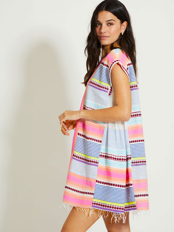 Woman Standing Wearing lemlem ELINA | Caftan featuring  intricate stripes in sun-washed hues and a Tibeb-inspired pattern in rich dark plum