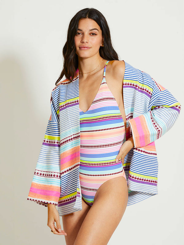 Woman Standing Wearing lemlem TERARA | Jacket featuring  intricate stripes in sun-washed hues and a Tibeb-inspired pattern in rich dark plum