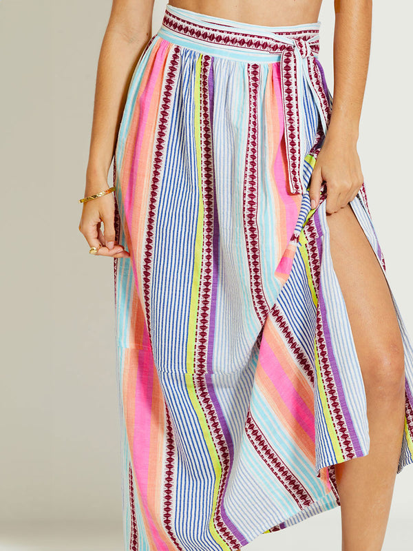 Close up on a Woman Standing Wearing lemlem TOLA | Skirt featuring  intricate stripes in sun-washed hues and a Tibeb-inspired pattern in rich dark plum