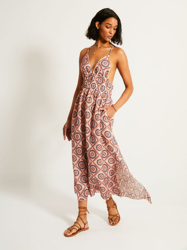 Woman Standing Wearing lemlem GETE | Triangle Dress featuring a Yani Tibeb-inspired pattern in peach, rust, and orchid hues, accented with a bold citrus yellow pop.
