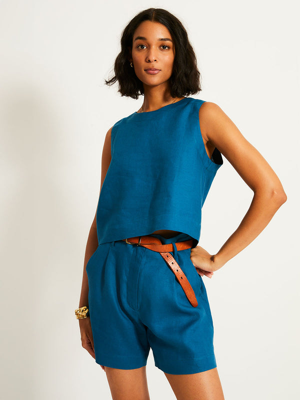Woman Standing Wearing lemlem ADOWA | Shell Tank  featuring a rich mid-blue green color and matching shorts
